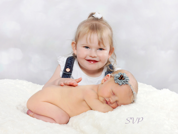 Newborn baby girl and her big sister 